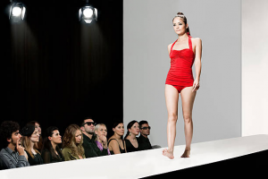 Fashion marketing and communication: a stylish model walking the runway at a high-end fashion show